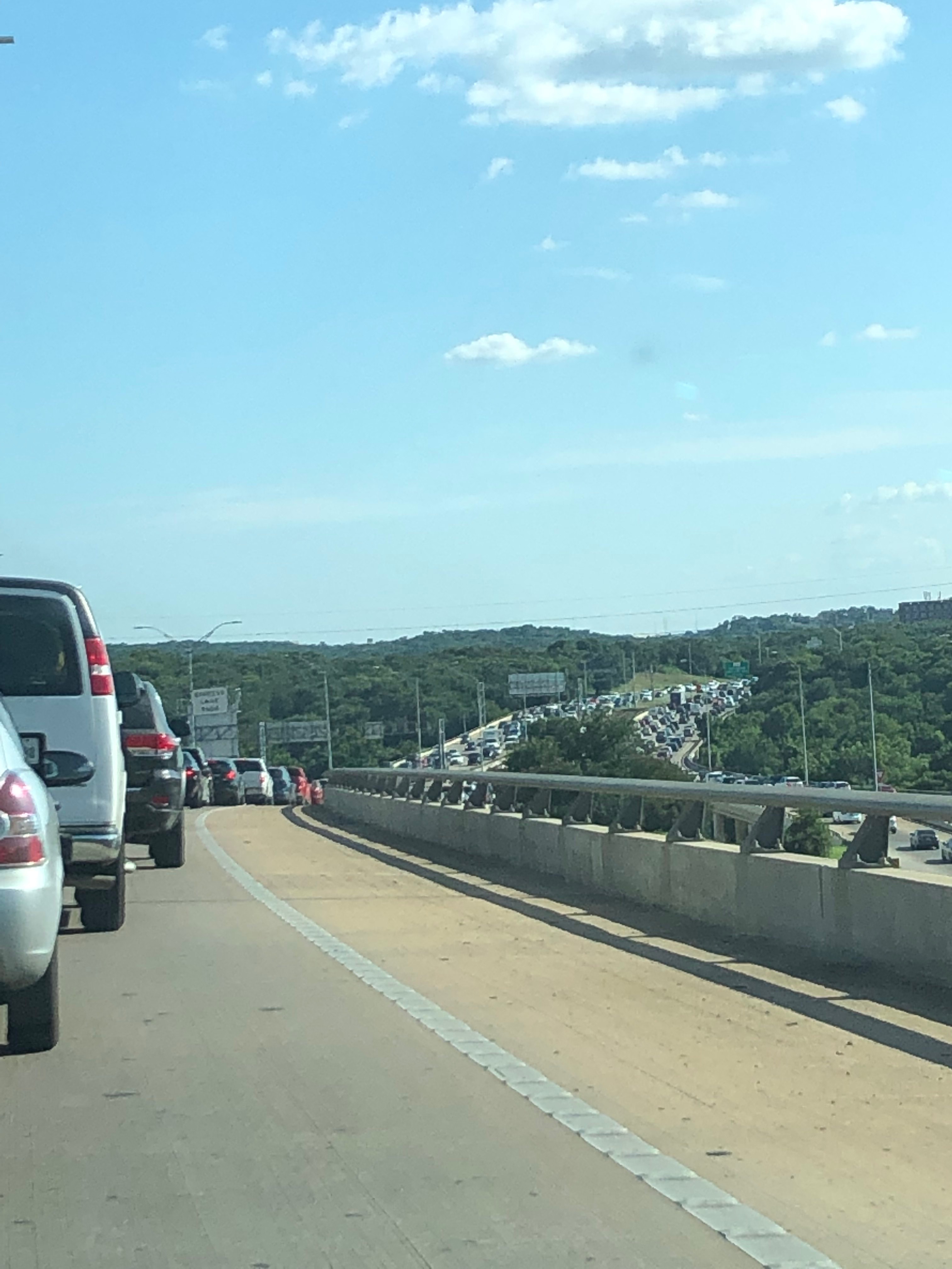 Cars clog the highway as far as the eye can see.