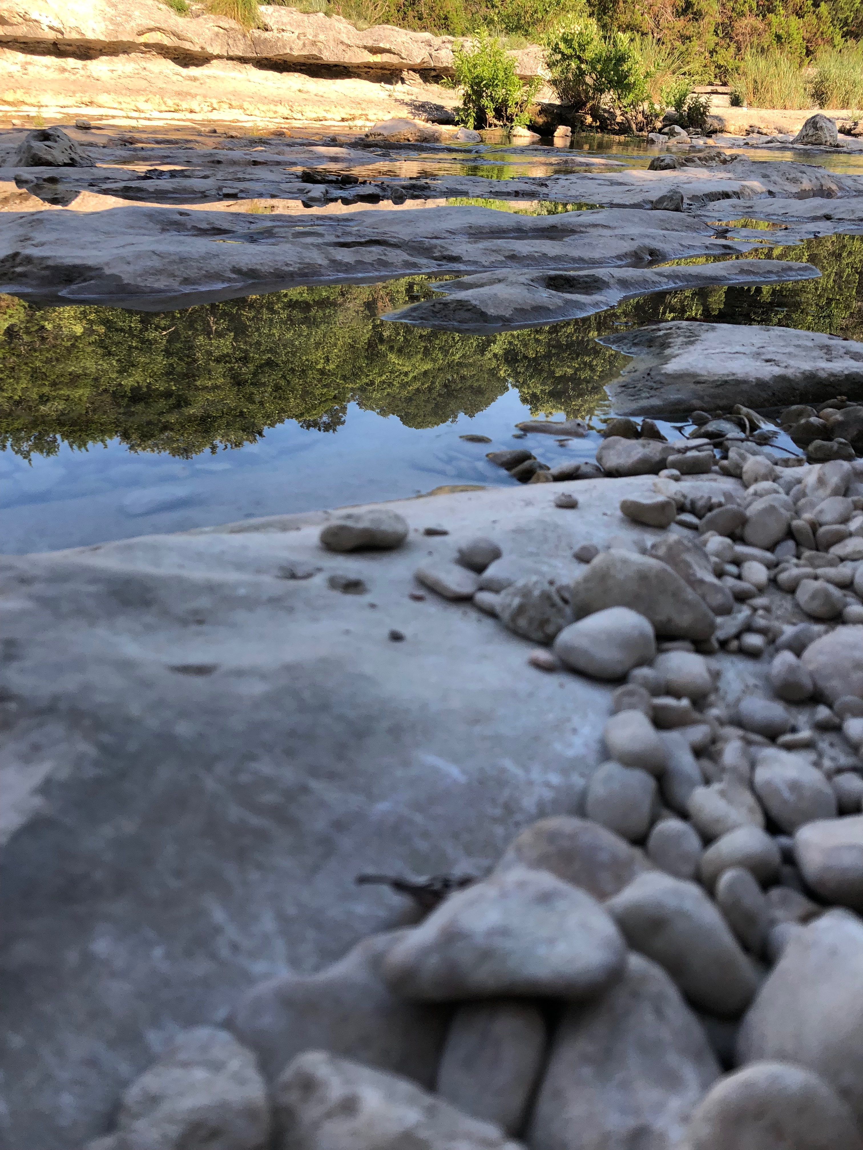 Riverbed is exposed and a small amount of moving water runs over.