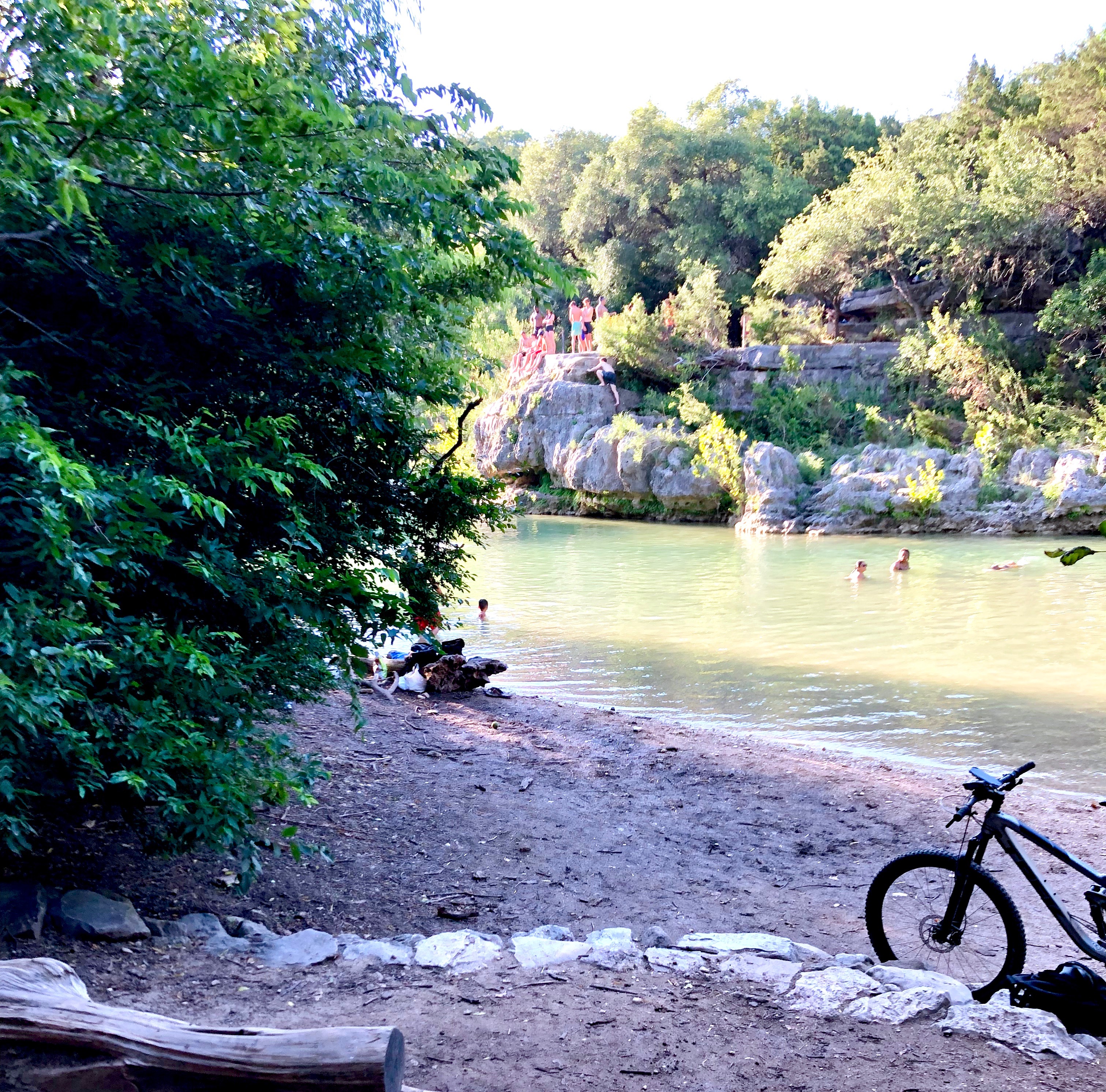 People leave their bikes on the trail to get in the water.