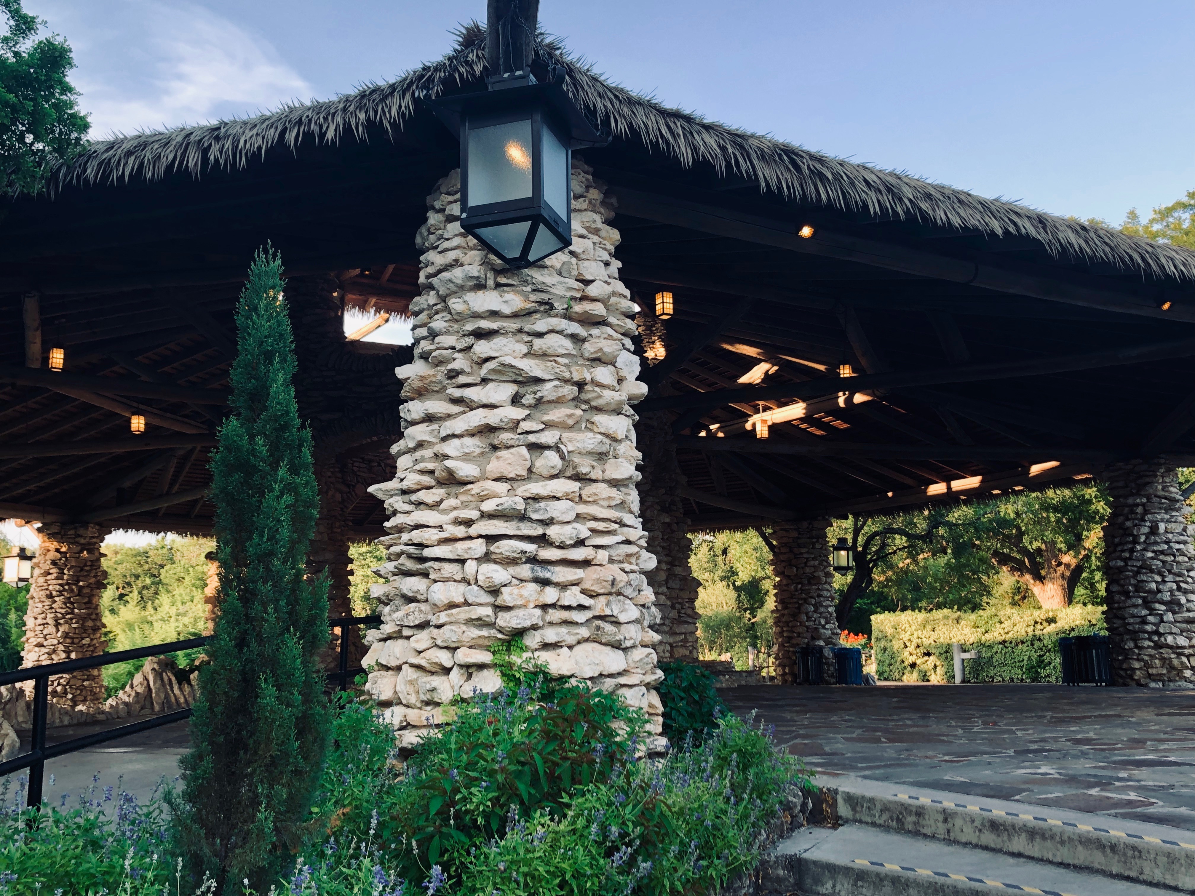 Columns made with stacked rock hold up canopy made of wood and dried grass.