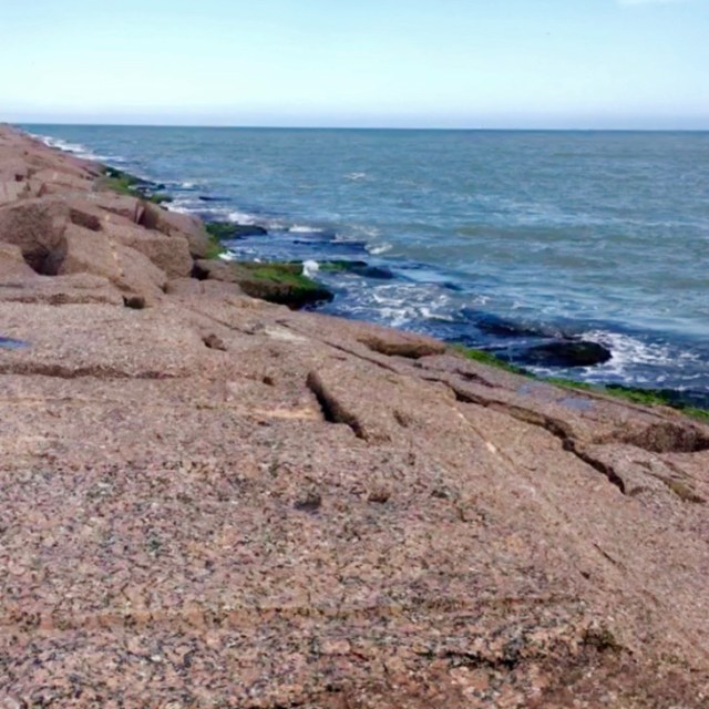Slabs of granite line seaside.