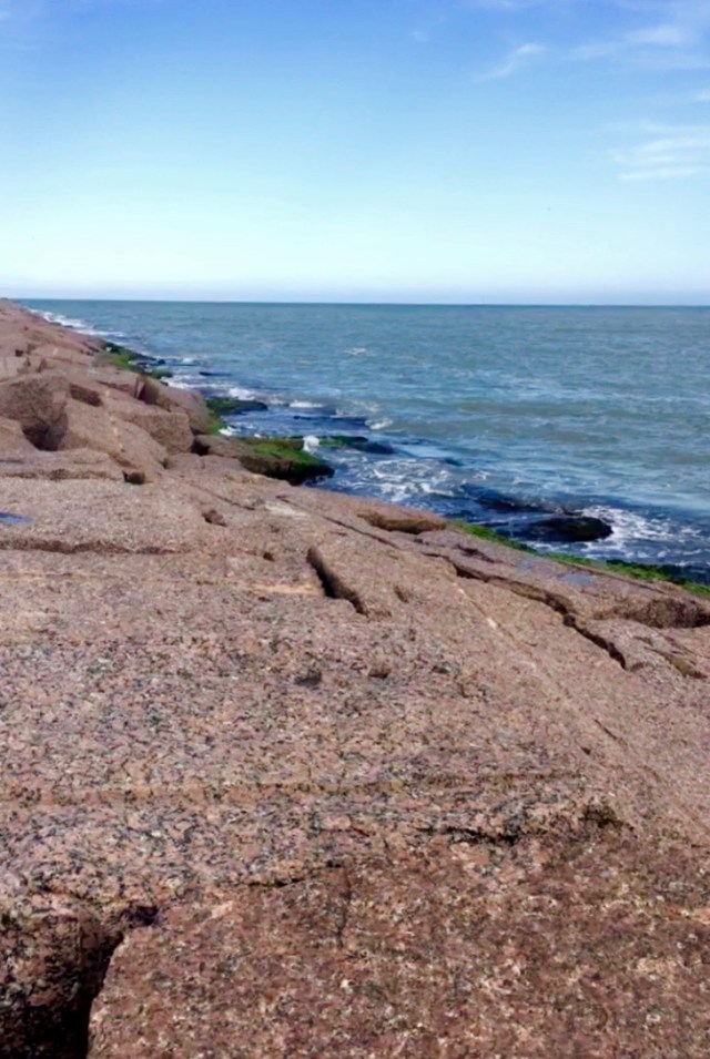 Slabs of granite line seaside.